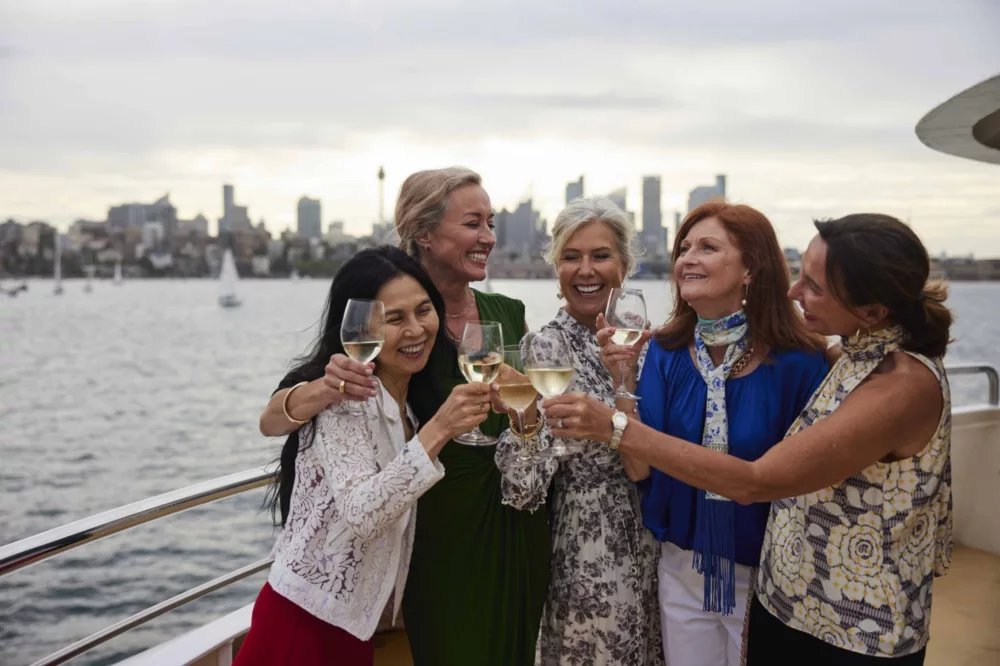 Ladies group celebration on deck with wine, BB